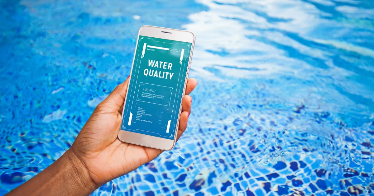 App measuring water quality on the screen of smartphone in front.
